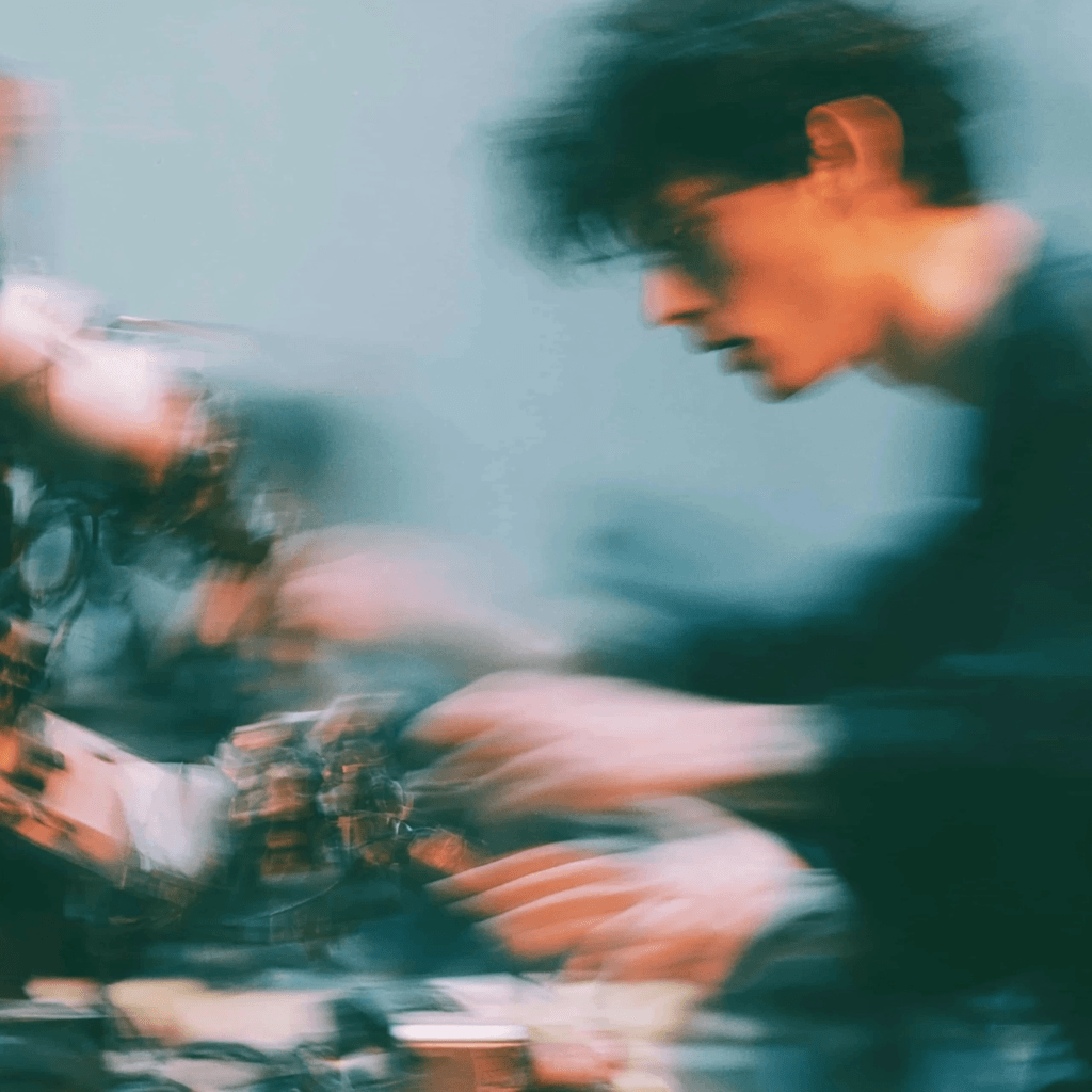 A young person and a robotic arm reaching toward one another.